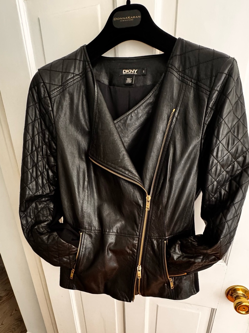 Leather with quilted detail. Gold zipper  hardware. Jersey inset on sleeves.